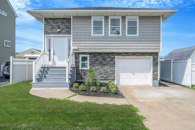 248 E Shore Rd, Lindenhurst, NY 11757 - view of front of house with stone siding, concrete driveway, and an attached garage