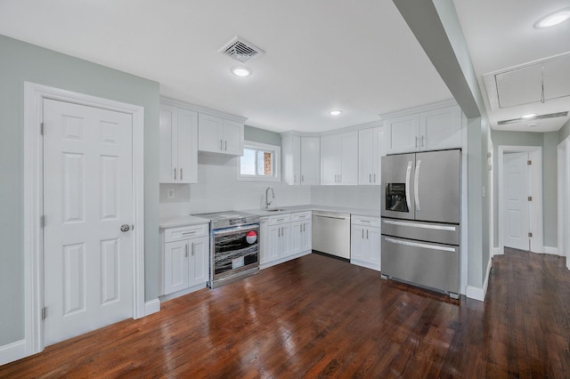 248 E Shore Rd, Lindenhurst, NY 11757 - kitchen with appliances with stainless steel finishes, light countertops, white cabinetry, and recessed lighting