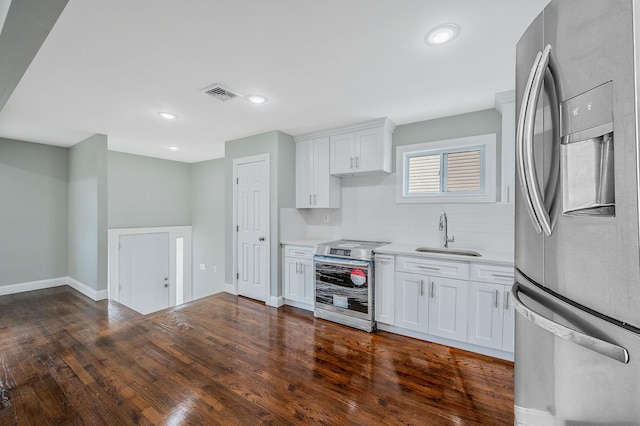 248 E Shore Rd, Lindenhurst, NY 11757 - kitchen with stainless steel appliances, light countertops, decorative backsplash, dark wood finished floors, and white cabinets