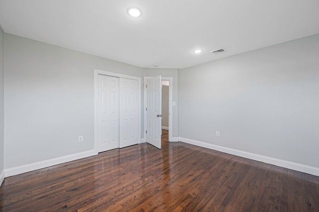 248 E Shore Rd, Lindenhurst, NY 11757 - unfurnished bedroom with dark wood-type flooring, a closet, and recessed lighting