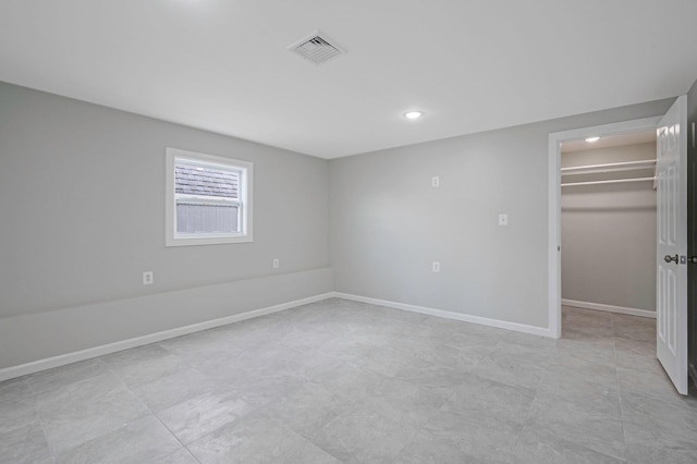 248 E Shore Rd, Lindenhurst, NY 11757 - unfurnished bedroom featuring a walk in closet and recessed lighting