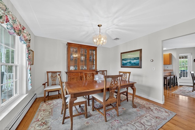 106 Maple Ave, Goshen, NY 10924 - dining room featuring baseboard heating, a chandelier, and light wood-style flooring