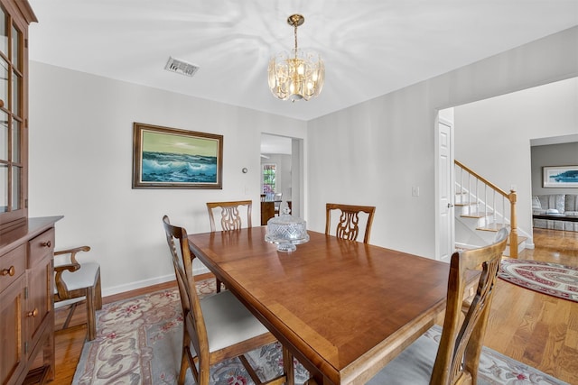 106 Maple Ave, Goshen, NY 10924 - dining area with light wood-style floors, stairs, and a chandelier