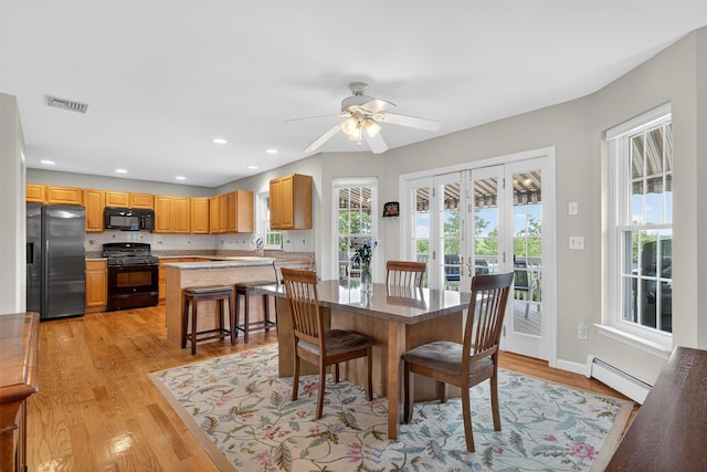 106 Maple Ave, Goshen, NY 10924 - dining room featuring a baseboard heating unit, light wood-style flooring, ceiling fan, and recessed lighting