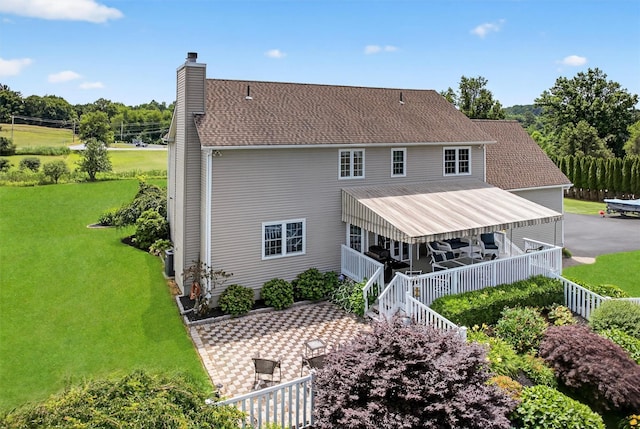 106 Maple Ave, Goshen, NY 10924 - back of house with a chimney and a lawn