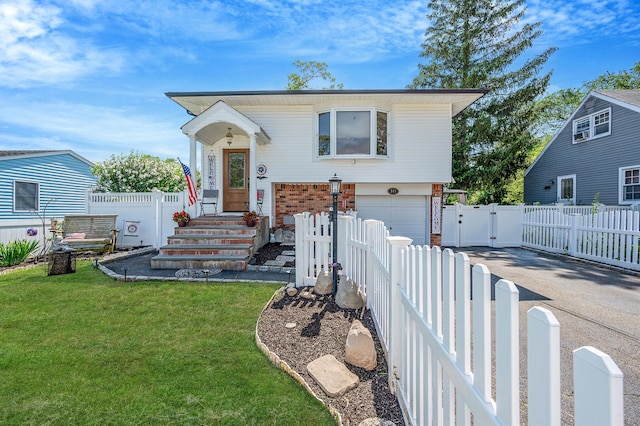 511 N Delaware Ave, Lindenhurst, NY 11757 - view of front of house featuring a gate, an attached garage, brick siding, driveway, and entry steps