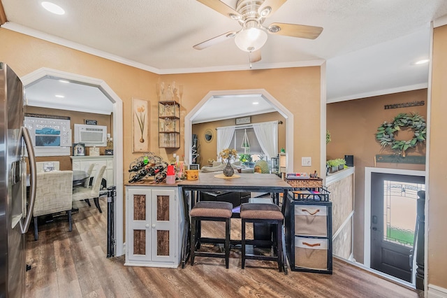511 N Delaware Ave, Lindenhurst, NY 11757 - kitchen with freestanding refrigerator, wood finished floors, arched walkways, a ceiling fan, and ornamental molding