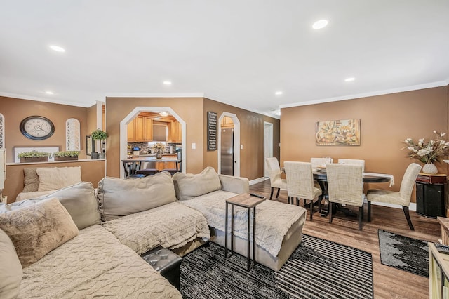 511 N Delaware Ave, Lindenhurst, NY 11757 - living room with arched walkways, recessed lighting, crown molding, and wood finished floors