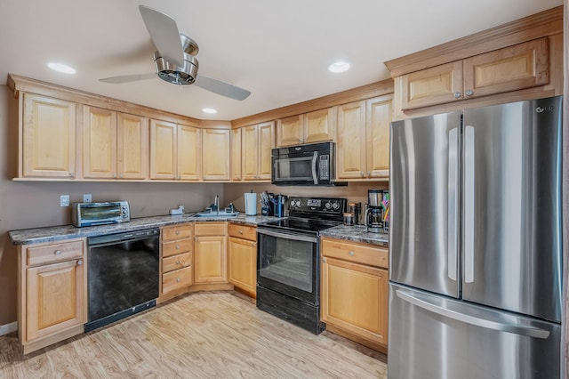 511 N Delaware Ave, Lindenhurst, NY 11757 - kitchen with black appliances, light brown cabinets, light wood finished floors, ceiling fan, and dark stone counters