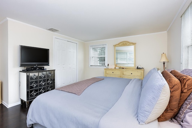 414 Pecan St, Lindenhurst, NY 11757 - bedroom featuring dark wood-type flooring, crown molding, and a closet
