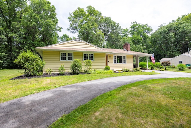 18 Alexander Blvd, Poughkeepsie, NY 12603 - ranch-style home featuring a chimney, a front yard, and asphalt driveway