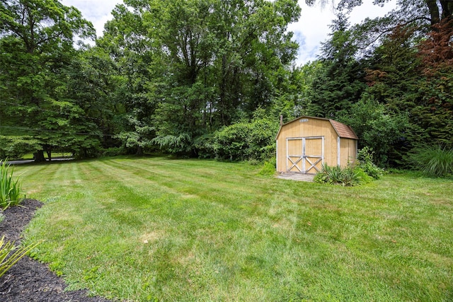 18 Alexander Blvd, Poughkeepsie, NY 12603 - view of green lawn with a storage shed and a wooded view