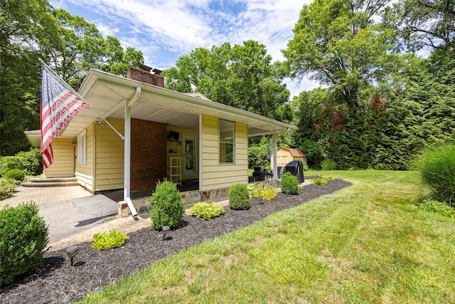 18 Alexander Blvd, Poughkeepsie, NY 12603 - bungalow with a chimney, a front lawn, and a shed
