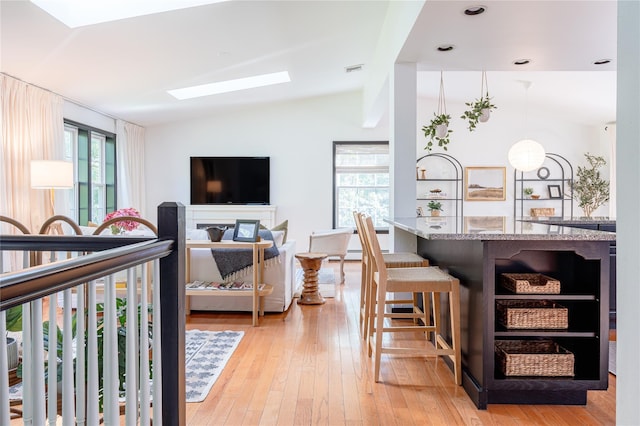 27 Maple Rd, Lake Peekskill, NY 10537 - living area with vaulted ceiling, healthy amount of natural light, and light wood-type flooring
