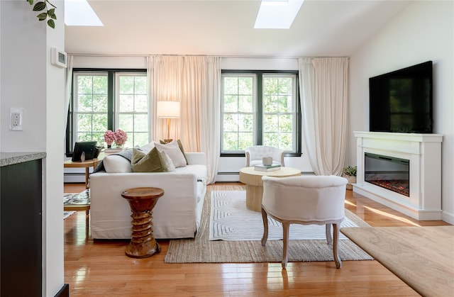 27 Maple Rd, Lake Peekskill, NY 10537 - living area featuring a skylight, plenty of natural light, and a glass covered fireplace