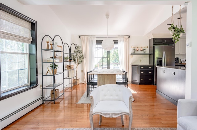 27 Maple Rd, Lake Peekskill, NY 10537 - living area with a baseboard heating unit, light wood finished floors, and lofted ceiling