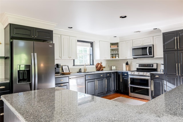 27 Maple Rd, Lake Peekskill, NY 10537 - kitchen featuring appliances with stainless steel finishes, stone counters, white cabinets, and ornamental molding