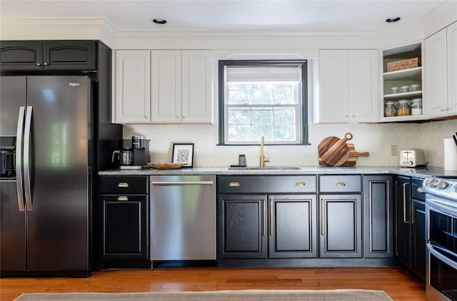 27 Maple Rd, Lake Peekskill, NY 10537 - kitchen with appliances with stainless steel finishes, white cabinets, light stone counters, decorative backsplash, and crown molding