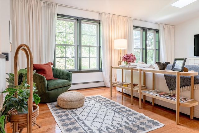 27 Maple Rd, Lake Peekskill, NY 10537 - sitting room with healthy amount of natural light, a baseboard heating unit, wood finished floors, and a skylight