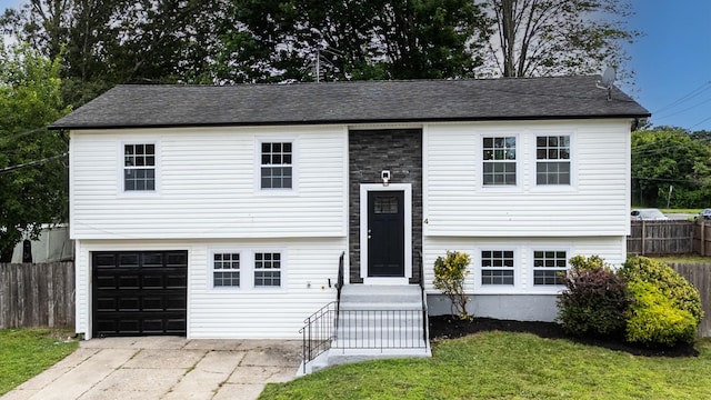 4 S Cardinal Ct, Islip, NY 11706 - split foyer home featuring a garage, driveway, and roof with shingles