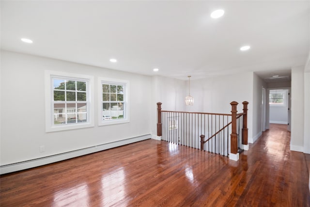 4 S Cardinal Ct, Islip, NY 11706 - unfurnished room with baseboard heating, healthy amount of natural light, wood finished floors, and recessed lighting