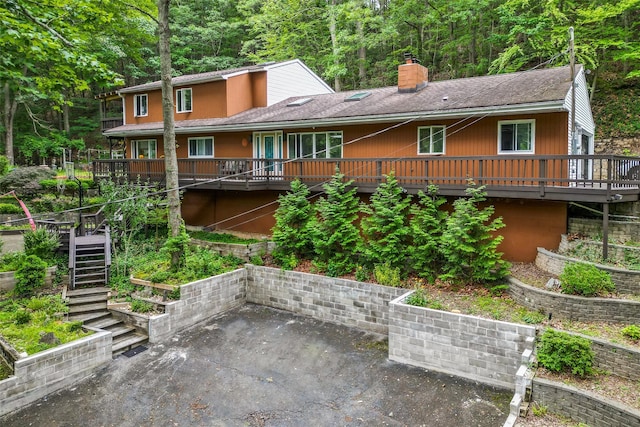 485 Harbor Rd, Cold Spring Harbor, NY 11724 - back of house with stairway, a patio area, a chimney, and a deck