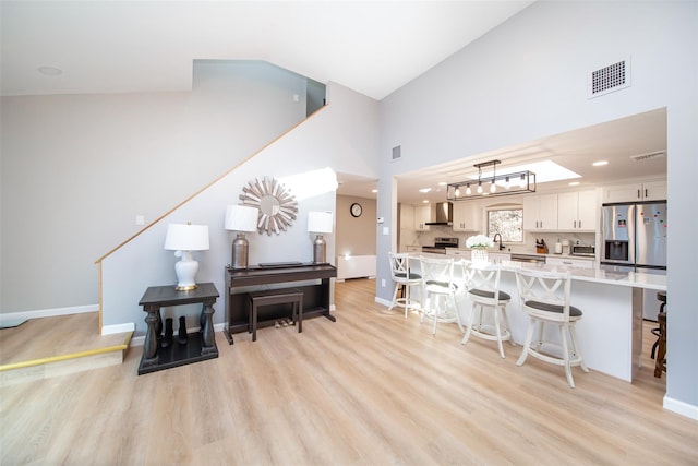 485 Harbor Rd, Cold Spring Harbor, NY 11724 - living area with light wood finished floors, high vaulted ceiling, and recessed lighting