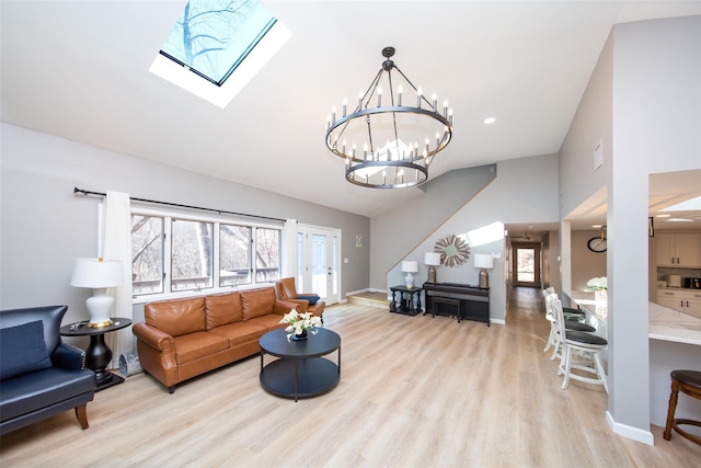 485 Harbor Rd, Cold Spring Harbor, NY 11724 - living area with plenty of natural light, wood finished floors, a skylight, a chandelier, and vaulted ceiling