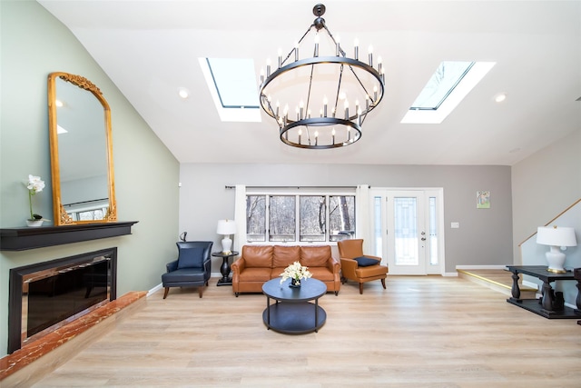 485 Harbor Rd, Cold Spring Harbor, NY 11724 - living room featuring a skylight, vaulted ceiling, a chandelier, wood finished floors, and recessed lighting