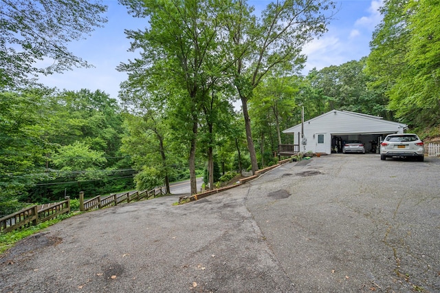 485 Harbor Rd, Cold Spring Harbor, NY 11724 - view of home's exterior with a garage and a view of trees