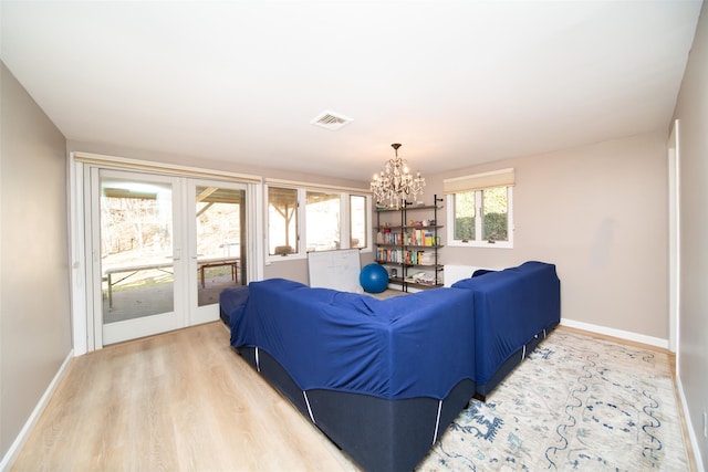 485 Harbor Rd, Cold Spring Harbor, NY 11724 - living room featuring a chandelier, light wood-type flooring, and french doors