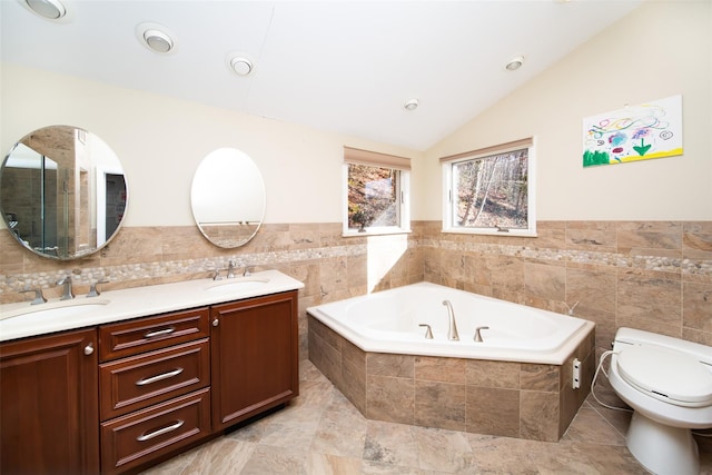 485 Harbor Rd, Cold Spring Harbor, NY 11724 - bathroom with tile walls, double vanity, a garden tub, lofted ceiling, and wainscoting