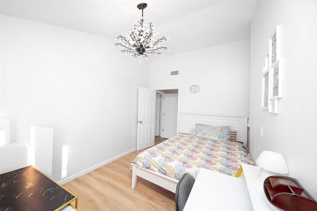 485 Harbor Rd, Cold Spring Harbor, NY 11724 - bedroom with wood finished floors and a chandelier