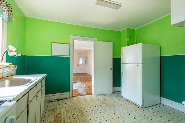 2 Florence St, North Baldwin, NY 11510 - kitchen featuring freestanding refrigerator, light flooring, ornamental molding, stove, and light countertops