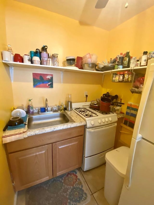 34 Columbus Ave Unit B20, Spring Valley, NY 10977 - kitchen with white appliances, light tile patterned floors, light countertops, and ceiling fan
