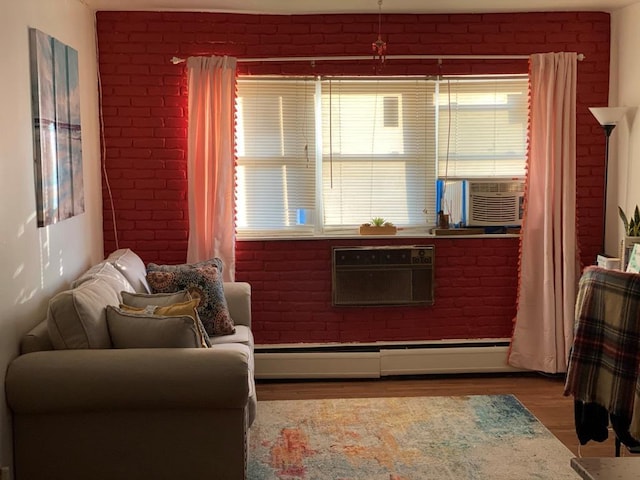 34 Columbus Ave Unit B20, Spring Valley, NY 10977 - living area with cooling unit, baseboard heating, wood finished floors, and a wall mounted air conditioner