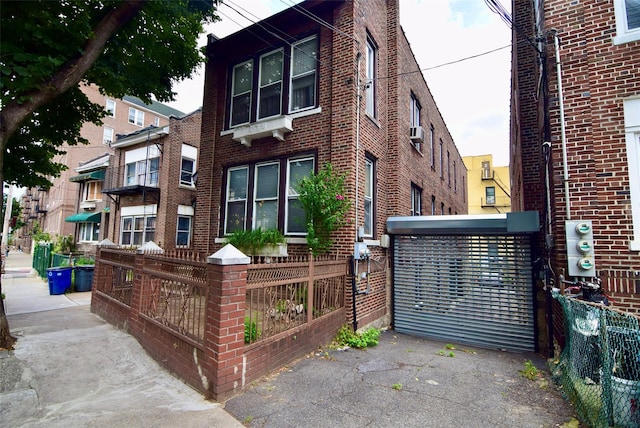 1860 Harrison Ave, Bronx, NY 10453 - view of building exterior with a fenced front yard