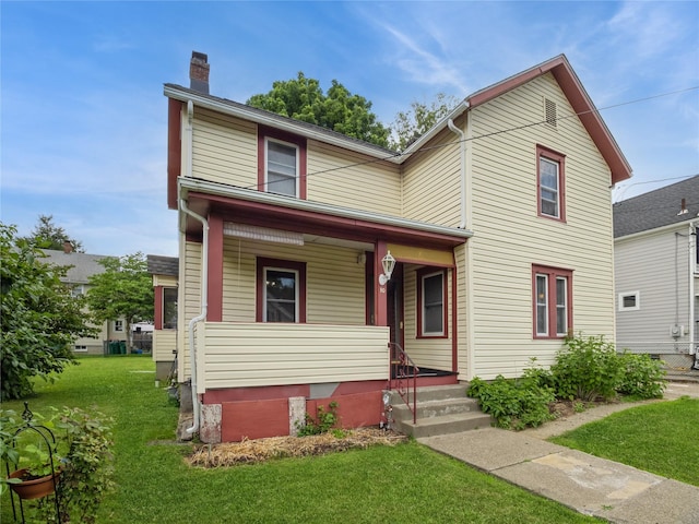 10 Vail Ave, Beacon, NY 12508 - traditional home featuring covered porch, a chimney, and a front lawn