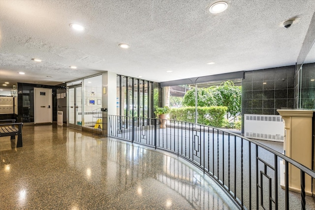 89-40 151st Ave Unit 1M, Howard Beach, NY 11414 - common area featuring a textured ceiling, a security system, and recessed lighting