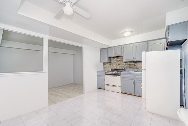 127 Keating Pl, Staten Island, NY 10314 - kitchen featuring white appliances, gray cabinetry, ceiling fan, and backsplash