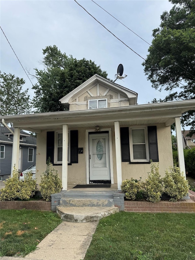 80 Vancott Ave, Hempstead, NY 11550 - bungalow with stucco siding and a porch