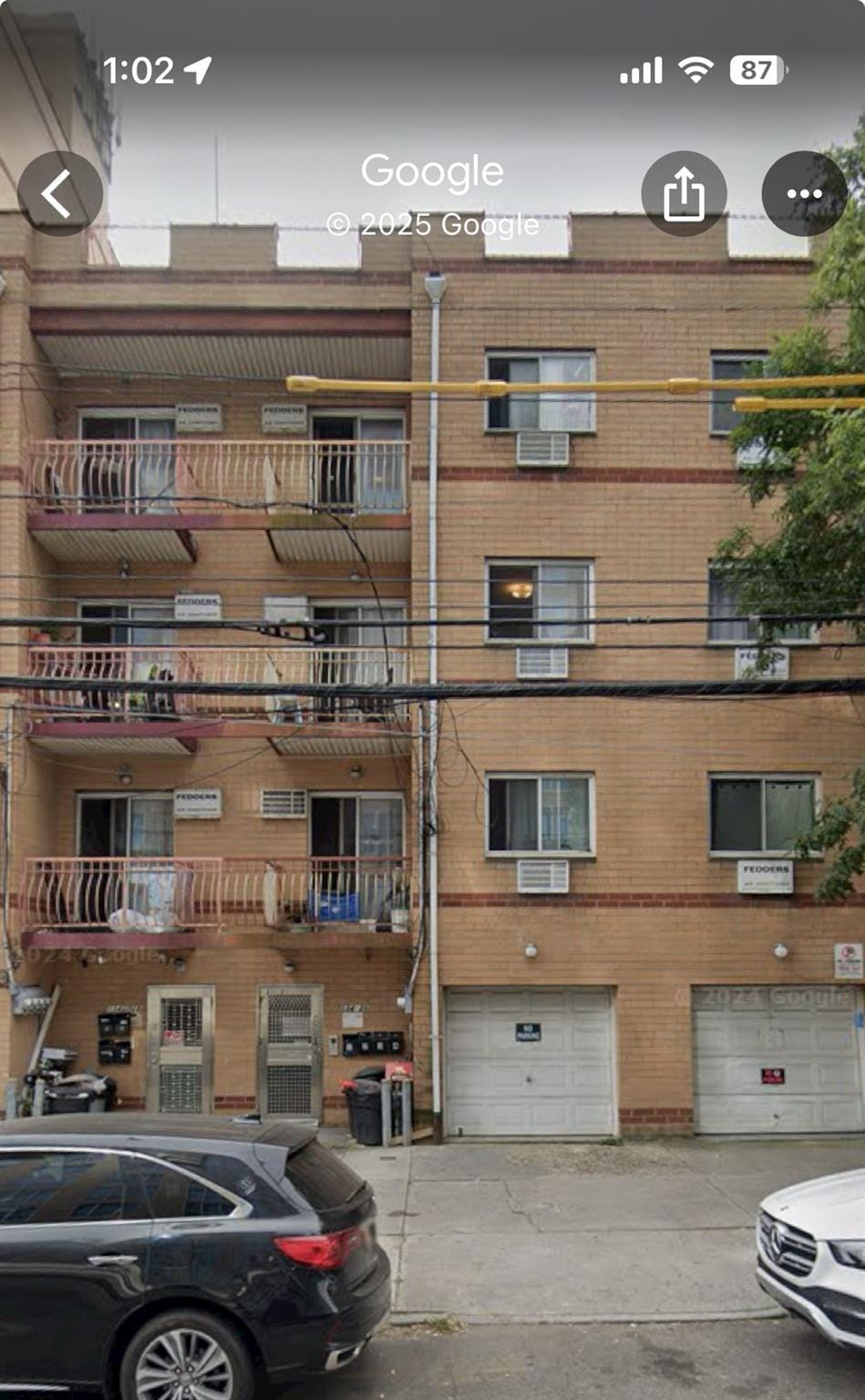13426 35th Ave, Flushing, NY 11354 - view of building exterior with a garage and driveway