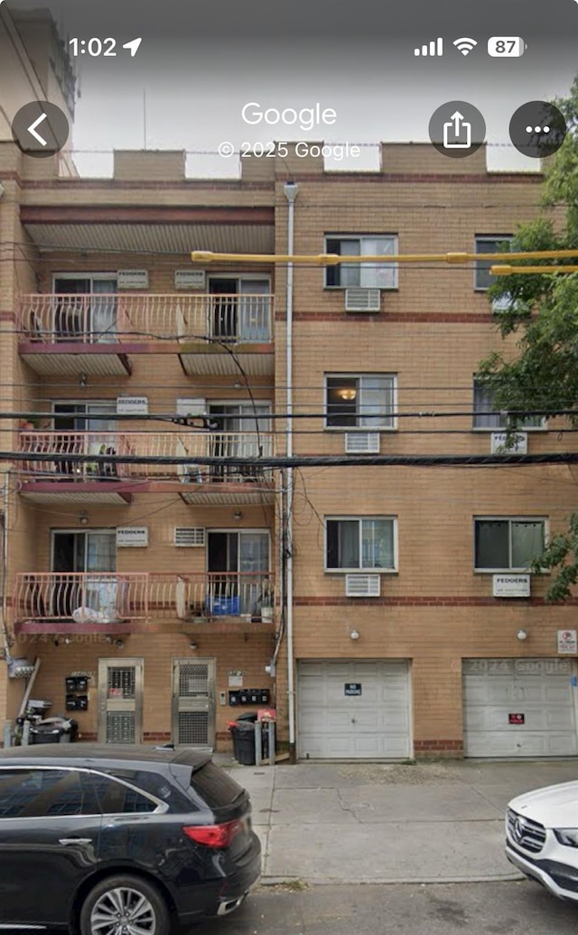 13426 35th Ave, Flushing, NY 11354 - view of building exterior with a garage and driveway