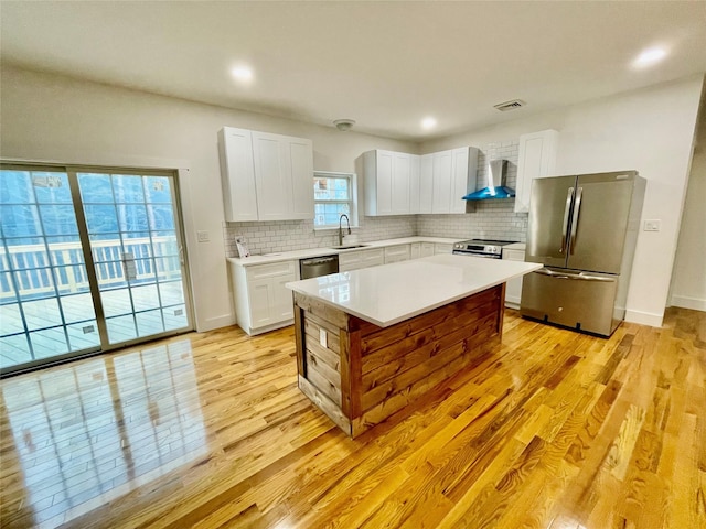 109 Krystyna Rd, White Lake, NY 12787 - kitchen with stainless steel appliances, wall chimney range hood, light countertops, tasteful backsplash, and recessed lighting