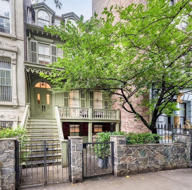 17E 128th St, New York Manhattan, NY 10035 - view of front facade with a gate, a fenced front yard, and mansard roof