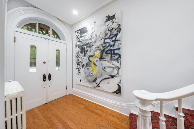 17E 128th St, New York Manhattan, NY 10035 - entryway with light wood finished floors and ornamental molding