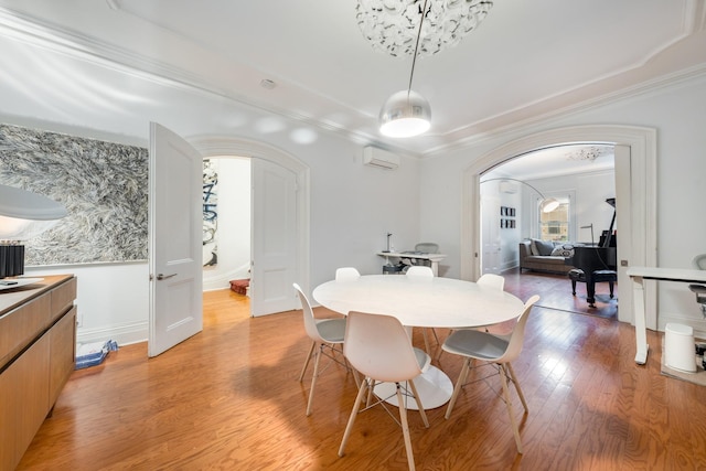 17E 128th St, New York Manhattan, NY 10035 - dining space with arched walkways, ornamental molding, and light wood-type flooring