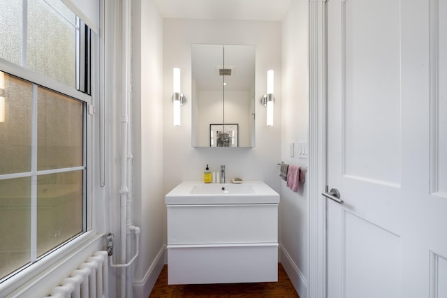 17E 128th St, New York Manhattan, NY 10035 - bathroom featuring vanity, radiator, and wood finished floors