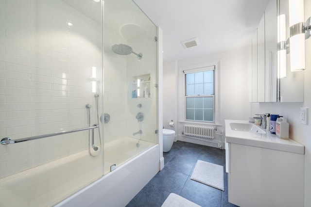 17E 128th St, New York Manhattan, NY 10035 - bathroom with radiator, vanity, combined bath / shower with glass door, and tile patterned floors