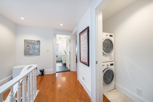 17E 128th St, New York Manhattan, NY 10035 - washroom with estacked washer and dryer, light wood finished floors, and recessed lighting